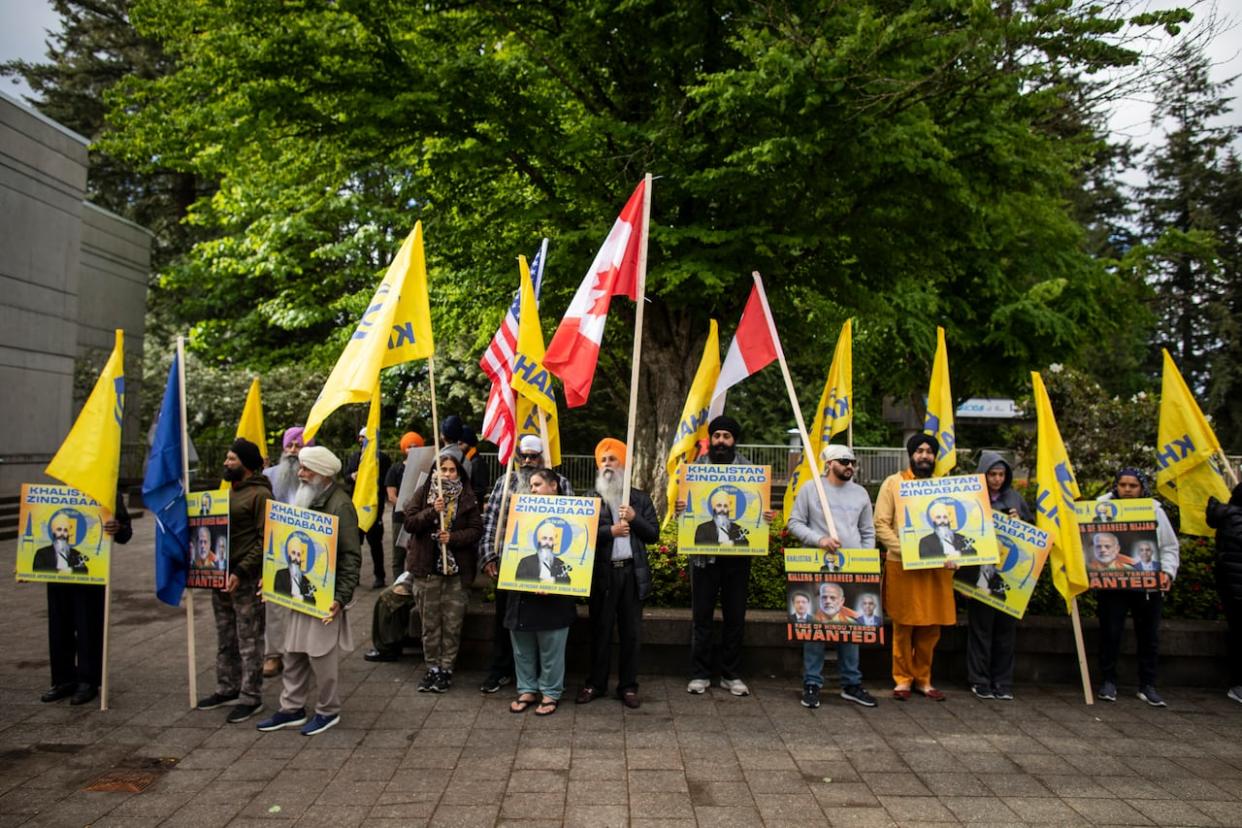 Supporters of slain Sikh activist Hardeep Singh Nijjar outside provincial court in Surrey, B.C., where three men charged with his murder were due to appear on Tuesday. (Ben Nelms/CBC - image credit)