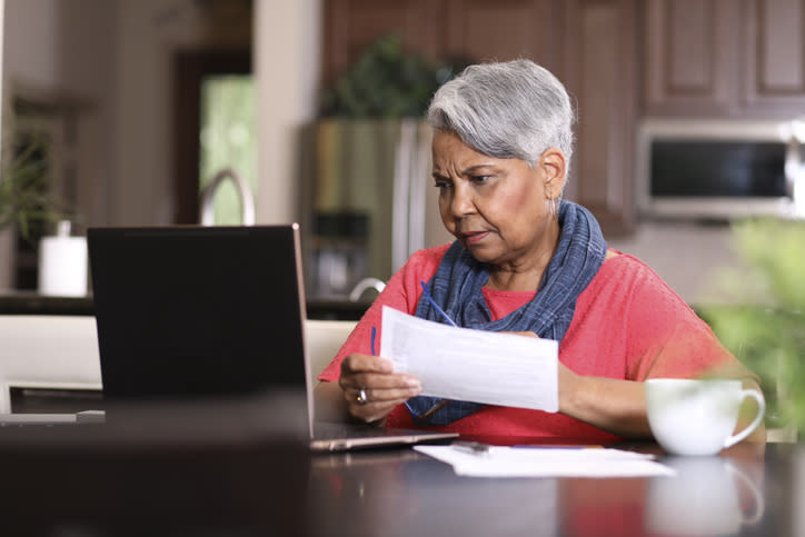 A senior woman considering the benefits and drawbacks of taking a reverse mortgage.