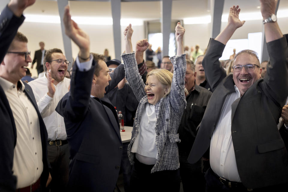 From left, members of right wing SVP Swiss People's Party, Mike Egger, Michael Goette, Esther Friedli, and Walter Gartmann, cheer in St. Gallen, Switzerland, late Sunday, Oct. 22, 2023. The anti-immigration Swiss People’s Party rebounded from searing losses four years ago, expanding its hold as the largest parliamentary faction, while environmentally-minded parties lost ground despite record glacier melt in the Alpine country, official election results showed. (Christian Merz/Keystone via AP)