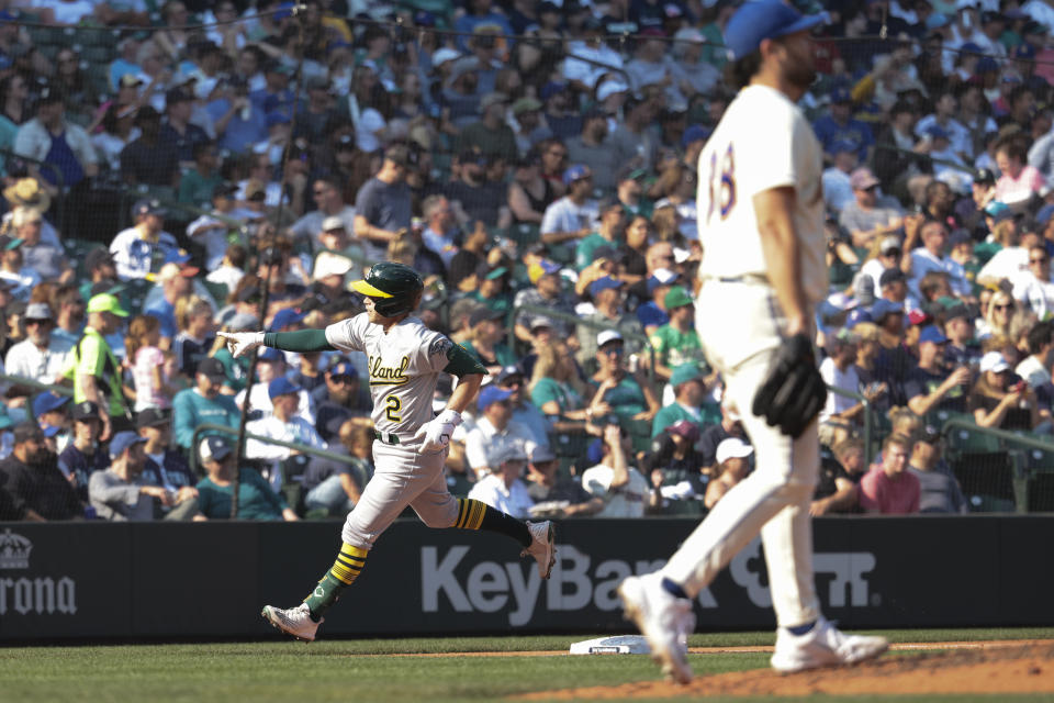 Oakland Athletics' Nick Allen, left, rounds third after hitting a two-run home run as Seattle Mariners starting pitcher Robbie Ray, right, walks to the mound during the sixth inning of a baseball game, Sunday, Oct. 2, 2022, in Seattle. (AP Photo/Jason Redmond)