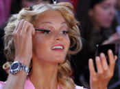 <p>Even seemingly perfect models need a little bit of help and Erin Heatherton is no exception touching up her mascara before she hits the runway.</p>