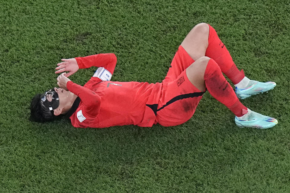 South Korea's Son Heung-min reacts on the pitch after a tackle during the World Cup round of 16 soccer match between Brazil and South Korea, at the Education City Stadium in Al Rayyan, Qatar, Monday, Dec. 5, 2022. (AP Photo/Pavel Golovkin)