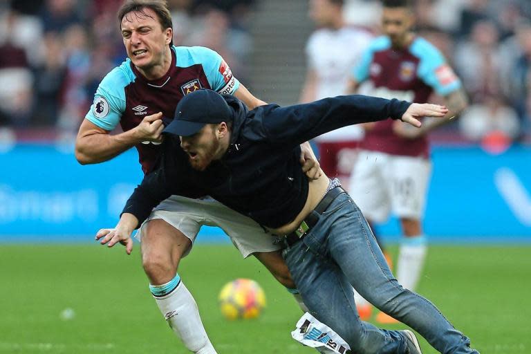 West Ham fans banned for three years over ‘moronic’ pitch invasion