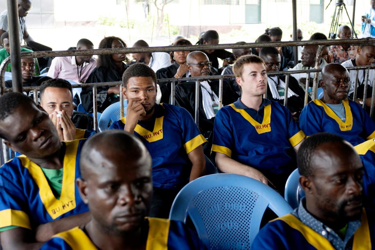 <span>Benjamin Reuben Zalman-Polun, Marcel Malanga and Tyler Thompson (in back row) attend court in Kinshasa on 13 September.</span><span>Photograph: Samy Ntumba Shambuyi/AP</span>