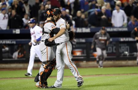 Oct 5, 2016; New York City, NY, USA; San Francisco Giants starting pitcher Madison Bumgarner (right) and catcher Buster Posey (left) celebrate the win against the New York Mets in the National League wild card playoff baseball game at Citi Field. Mandatory Credit: Anthony Gruppuso-USA TODAY Sports