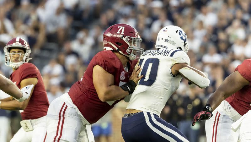 Alabama offensive lineman Darrian Dalcourt (71) blocks Utah State linebacker AJ Vongphachanh (10) during the first half of an NCAA college football game, Saturday, Sept. 3, 2022, in Tuscaloosa, Ala.
