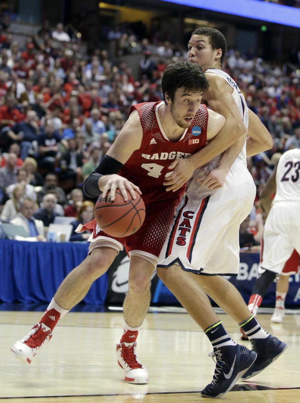 Wisconsin forward Frank Kaminsky, left, tries to drive past Arizona forward Aaron Gordon during the second half in a regional final NCAA college basketball tournament game, Saturday, March 29, 2014, in Anaheim, Calif. (AP Photo/Alex Gallardo)