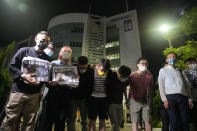 Reporters of Apple Daily bow to thank their supporters at the headquarters in Hong Kong, Thursday, June 24, 2021. Hong Kong's pro-democracy Apple Daily newspaper will stop publishing Thursday, following last week's arrest of five editors and executives and the freezing of $2.3 million in assets under the city's year-old national security law. (AP Photo/Kin Cheung)