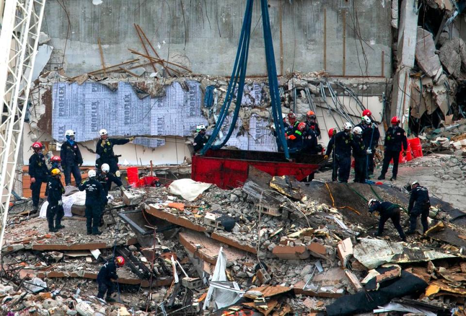 South Florida Urban Search and Rescue team looks through rubble for survivors at the partially collapsed Champlain Towers South condo building in Surfside, Florida, on Monday, June 28, 2021. As of Monday night, the death toll had climbed to 11 and 150 people are missing.