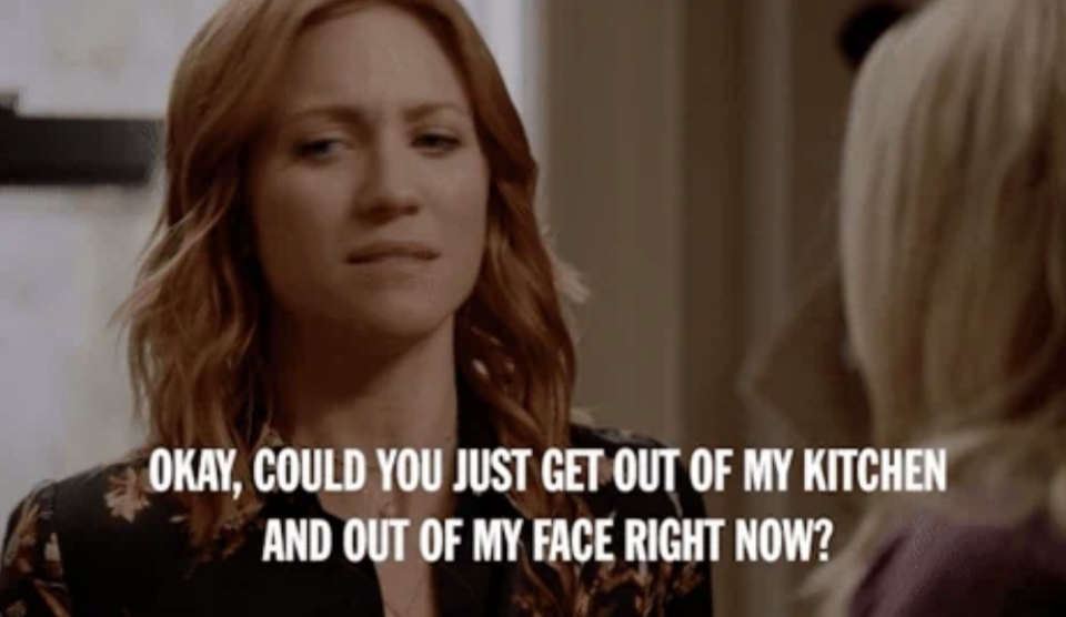A woman with red hair is speaking to someone offscreen. The overlaid text reads, "OKAY, COULD YOU JUST GET OUT OF MY KITCHEN AND OUT OF MY FACE RIGHT NOW?"