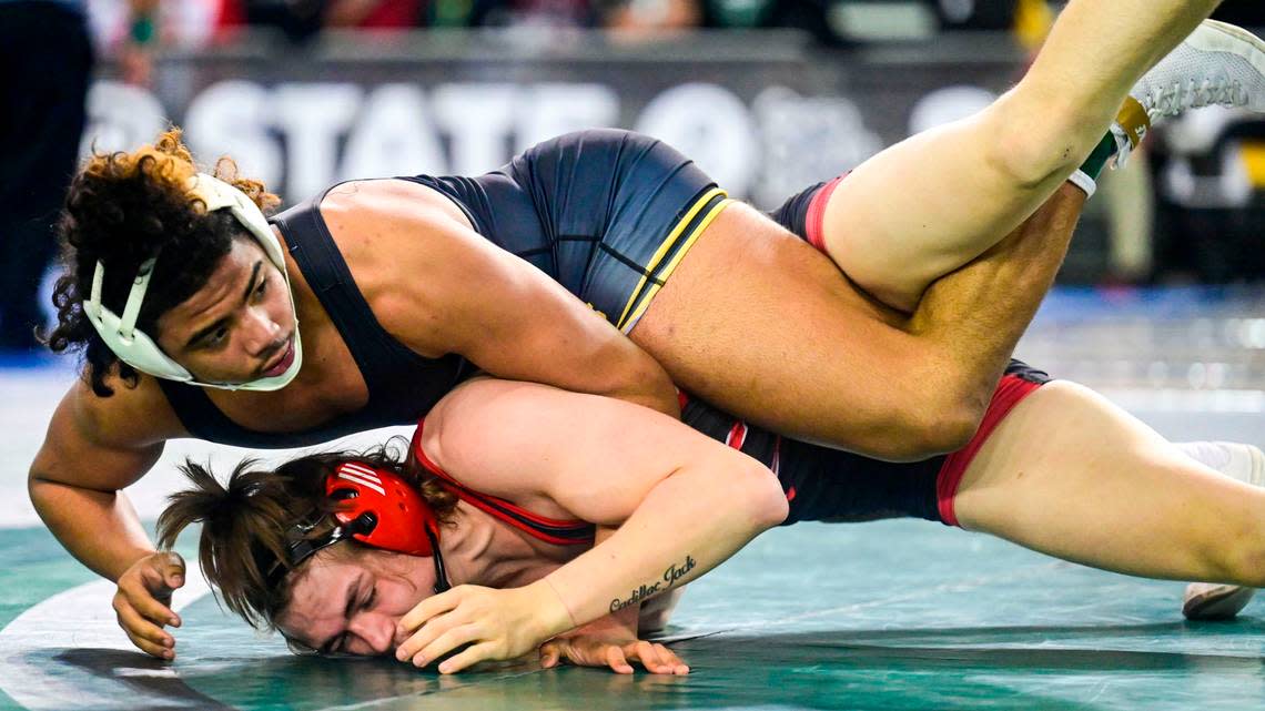 Lincoln’s Navarre Dixon does his best to keep Cheney’s Ezra Anderson in bounds during the second round of their 182-pound 3A quarterfinal match at Mat Classic XXXIII on Friday, Feb. 18, 2022, in Tacoma, Wash. Dixon pinned Anderson in 3 minutes, 13 seconds.