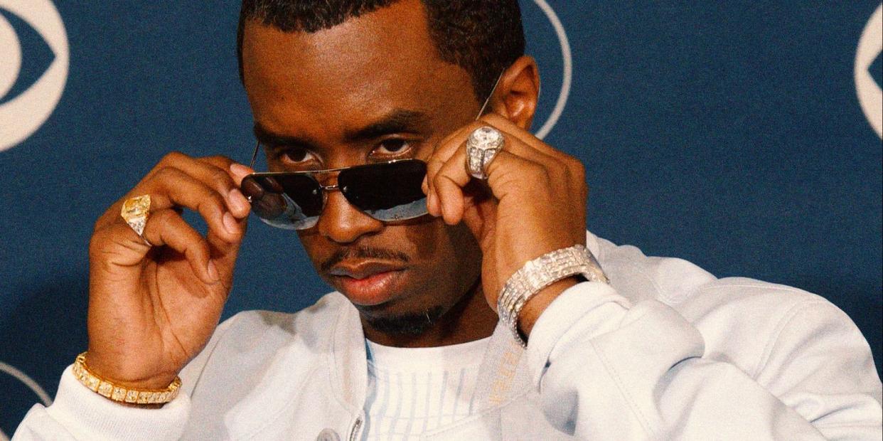 sean combs aka p diddy looks over his glasses on a red carpet