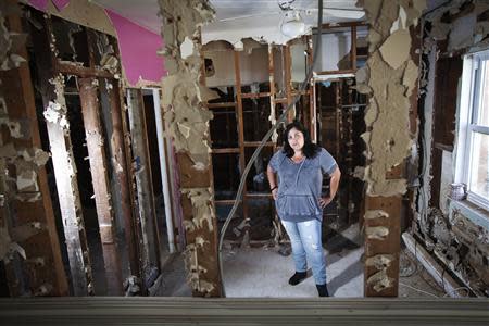 Nicole Chati poses for a portrait in what was her daughter's room after her home was damaged by Superstorm Sandy in the Staten Island borough of New York, September 20, 2013. REUTERS/Carlo Allegri