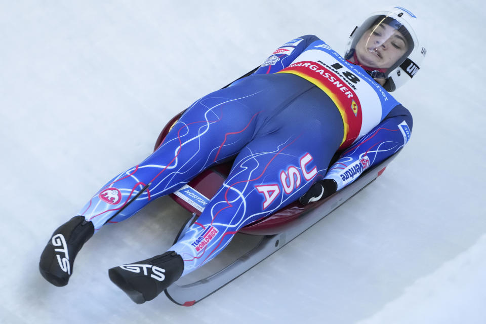 Summer Britcher of the United States speeds down the track during the women's race at the Luge World Cup in Igls near Innsbruck, Austria, Sunday, Dec. 19, 2021. (AP Photo/Matthias Schrader)