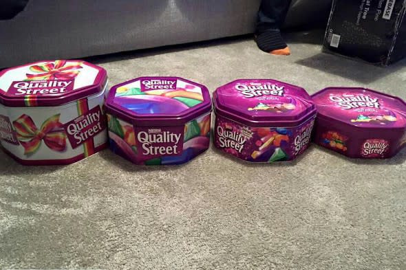 Four tins of Quality Street from over the years.