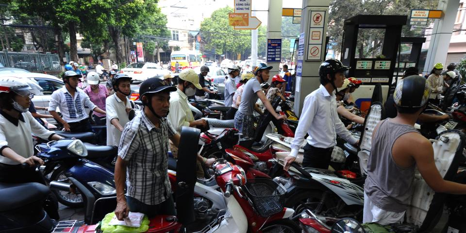 Motorcyclists rush to a filling station