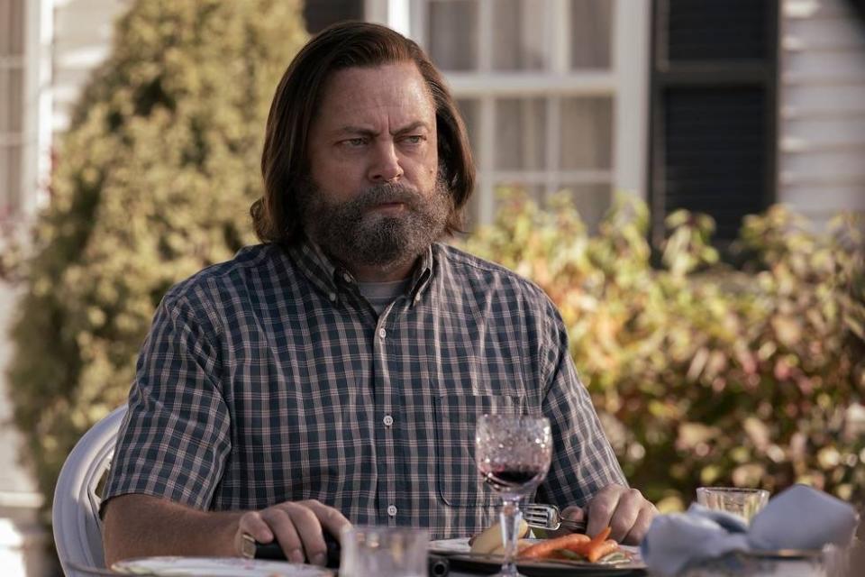 Bill (Nick Offerman) sits outside drinking wine in The Last of Us.