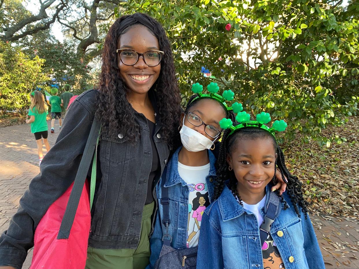 Savannah native Ayanna Robinson and her cousins watch the Savannah St. Patrick's Day Parade from Wright Square.