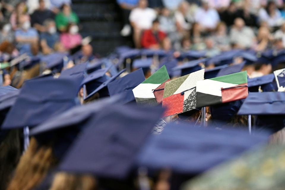 UNC Asheville students wear Palestinian flags on their caps during their commencement ceremony at Kimmel Arena, May 11, 2024.