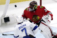 Chicago Blackhawks goalie Malcolm Subban, right, blocks a shot by Tampa Bay Lightning's Mathieu Joseph during the second period of an NHL hockey game in Chicago, Friday, March 5, 2021. (AP Photo/Nam Y. Huh)