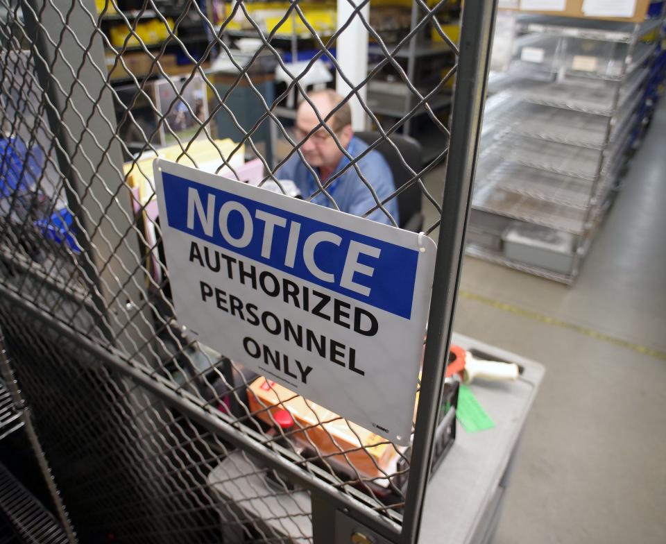 Bill Keiley, storeroom clerk for the Atrenne Company in Brockton, keeps tally of goods coming in and out of the building on Wednesday, Sept. 7, 2022. Since the company works on many government projects, security is a high priority.