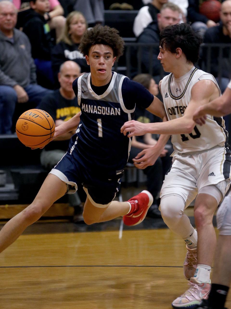 Manasquan's Darius Adams (#1) drives around Pt. Pleasant Boro's Shane Ryan (#10) during their game in Point Pleasant Boro Monday evening, January 23, 2023.  