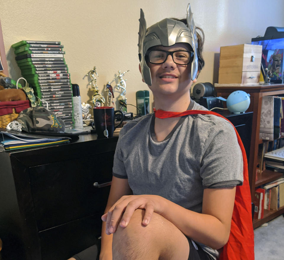 In this Sept. 25, 2020, photo provided by Meredith Christensen-Houghtelling, her son, Logan Houghtelling, dresses up as Thor to attend his virtual high school class in San Lorenzo, Calif. (Meredith Christensen-Houghtelling via AP)