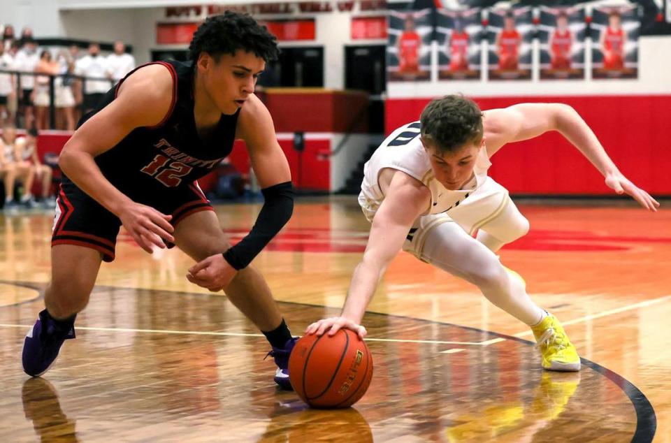 Keller guard Blake Bahr (10) and Trinity guard Jeremy Matos (12) go for a loose ball during the first half of a 6A Bi-District High School Basketball playoff game played Monday, February 22, 2021 at Colleyville Heritage High School. (Steve Nurenberg Special to the Star-Telegram)