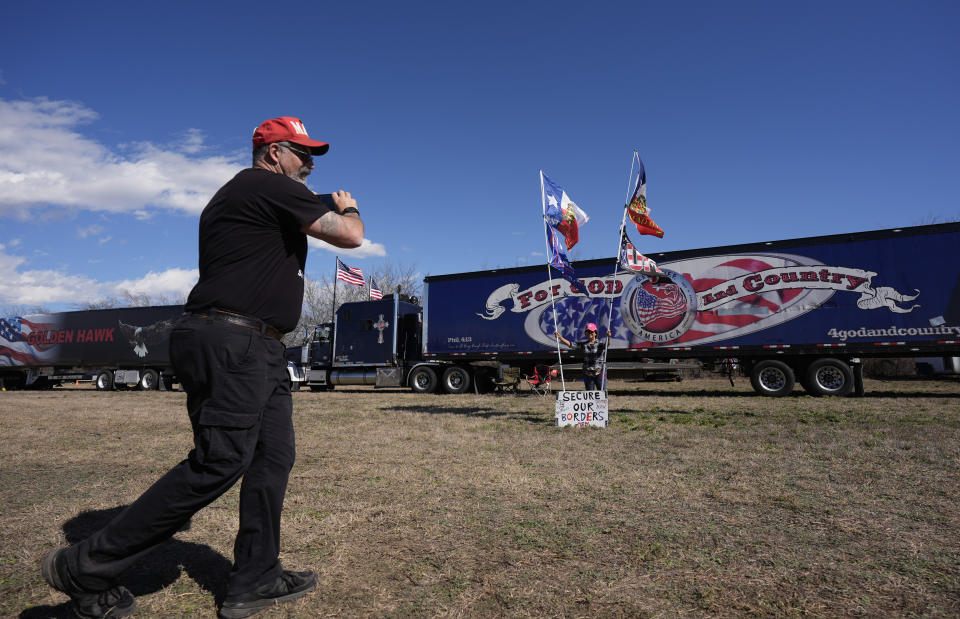 Phill Cady, left, takes a photo of his wife, Nina, during a "Take Our Border Back" rally, Saturday, Feb. 3, 2024, in Quemado, Texas. (AP Photo/Eric Gay)