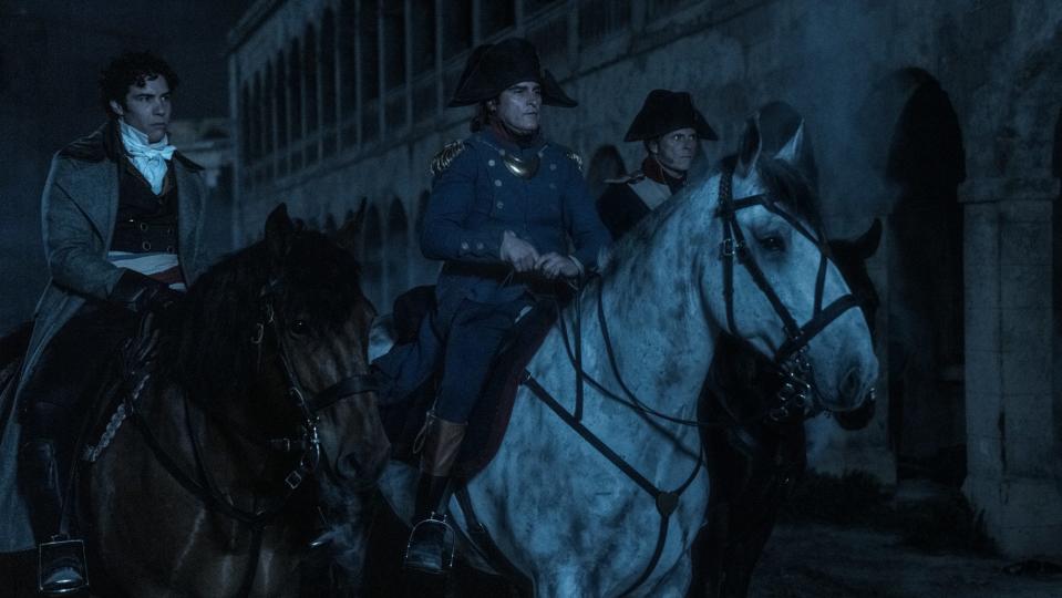 Paul Barras (Tahar Rahim, left,) and Napoleon (Joaquin Phoenix, center) prepare to launch the night attack in "Napoleon."