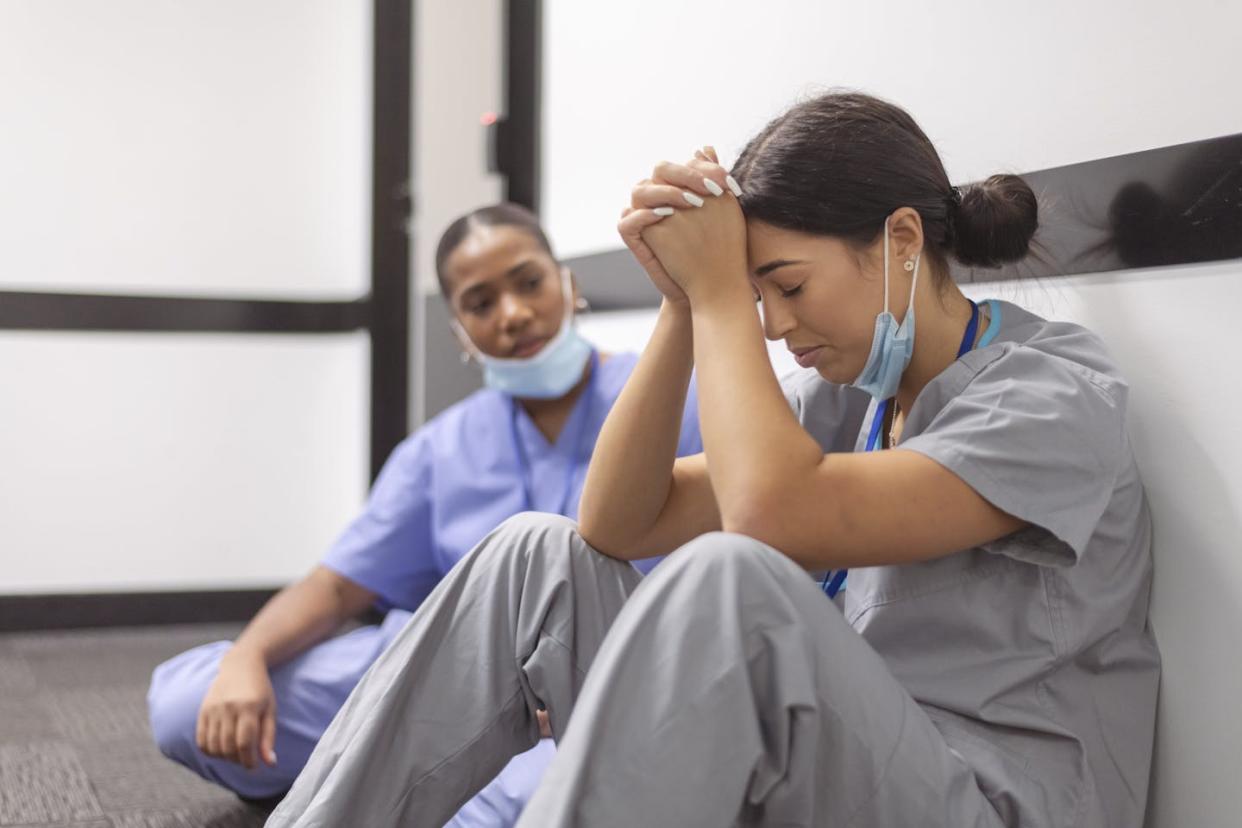 Moral injury can occur when someone must act against their values -- but also when they cannot act in line with their values. <a href="https://www.gettyimages.com/detail/photo/exhausted-and-stressed-nurses-need-a-break-from-royalty-free-image/1320406897?phrase=nurse+woman+upset&adppopup=true" rel="nofollow noopener" target="_blank" data-ylk="slk:Fly View Productions/E+ via Getty Images;elm:context_link;itc:0;sec:content-canvas" class="link ">Fly View Productions/E+ via Getty Images</a>