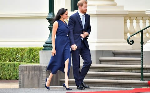 The Duke and Duchess of Sussex leave the crowds to attend a reception hosted by the governor of Victoria - Credit: Samir Hussein/WireImage