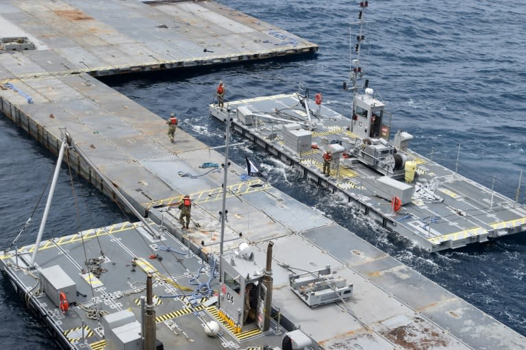 A handout photo courtesy of the US Central Command (CENTCOM) taken on April 26, 2024, shows construction work on the floating JLOTS pier in the Mediterranean Sea (-)