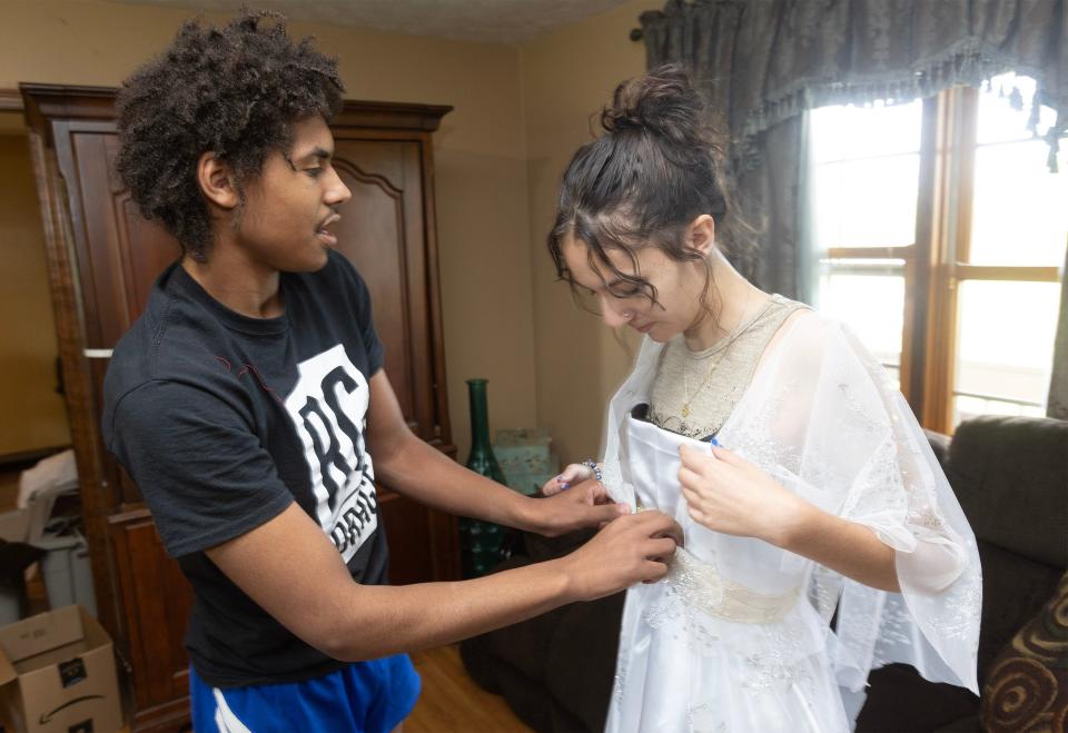 Randolph McFarren, 17, fits a costume for actor Aubrey Spitale for the musical he created based off the Jane Austen book "Mansfield Park" at his Lawrence Township home. The play will be performed June 9 and 10 at Northwest's Puffenberger Hall in Canal Fulton.