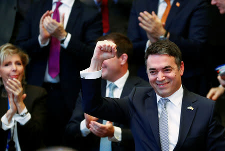 Macedonian Foreign Minister Nikola Dimitrov raises his fist during a signature ceremony of the accession protocol between the Republic of North Macedonia and NATO at the Alliance headquarters in Brussels, Belgium February 6, 2019. REUTERS/Francois Lenoir