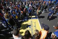 A large crowd gathers to pose for photos at the Boston Marathon finish line, one day before the race, Sunday, April 20, 2014, in Boston. (AP Photo/Robert F. Bukaty)