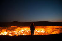 'Door to Hell' Standing at the edge of the Darvaza Crater in Turkmenistan. Known as the Door to Hell, this flaming crater has been burning for decades, fueled by the rich natural gas reserves found below the surface. (Photo and caption by Priscilla Locke/National Geographic Traveler Photo Contest) <br> <a href="http://travel.nationalgeographic.com/travel/traveler-magazine/photo-contest/2013/" rel="nofollow noopener" target="_blank" data-ylk="slk:See more and submit;elm:context_link;itc:0;sec:content-canvas" class="link ">See more and submit</a>