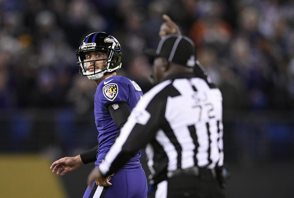 Baltimore Ravens kicker Justin Tucker, left, walks off the field after missing a point after attempt in the second half of an NFL football game against the New Orleans Saints, Sunday, Oct. 21, 2018, in Baltimore. (AP Photo/Nick Wass)