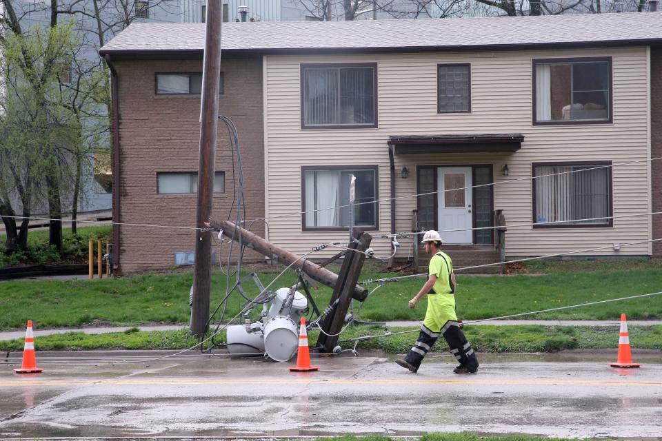 A MidAmerican Energy worker assesses a downed power line Tuesday, April 16, 2024 in Iowa City, Iowa.