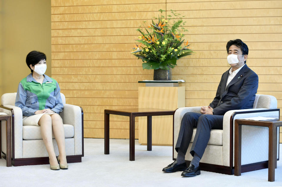 Tokyo Gov. Yuriko Koike, left, talks with Japanese Prime Minister Shinzo Abe at the prime minister's office in Tokyo Monday, July 6, 2020. Gov. Koike, who won her second term to head the Japanese capital in Sunday's election, met with her political rival, Prime Minister Abe and agreed to cooperate in their effort to fight against the coronavirus and to safely achieve the Olympics next year. (Yoshitaka Sugawara/Kyodo News via AP)