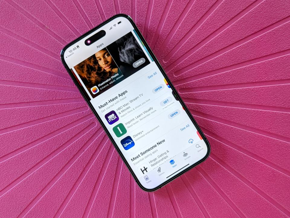App Store displayed on an iPhone 14 Pro against a pink background