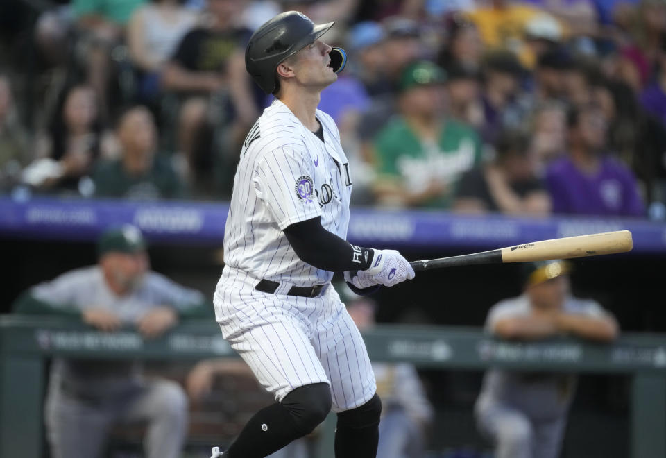 Colorado Rockies' Randal Grichuk watches his solo home run off Oakland Athletics starting pitcher JP Sears during the fourth inning of a baseball game Friday, July 28, 2023, in Denver. (AP Photo/David Zalubowski)