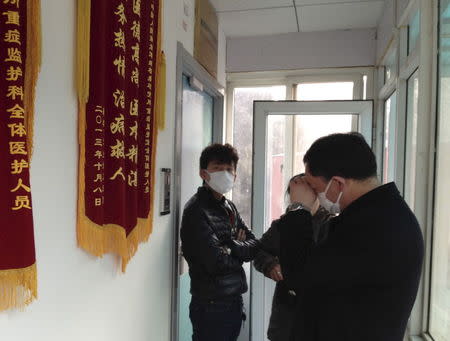 Friends of human rights activist Cao Shunli stand in front of an intensive care unit where Cao is hospitalized as they are not allowed to go inside of the unit at a hospital in Beijing in this March 1, 2014 file photo. REUTERS/Kim Kyung-Hoon/Files