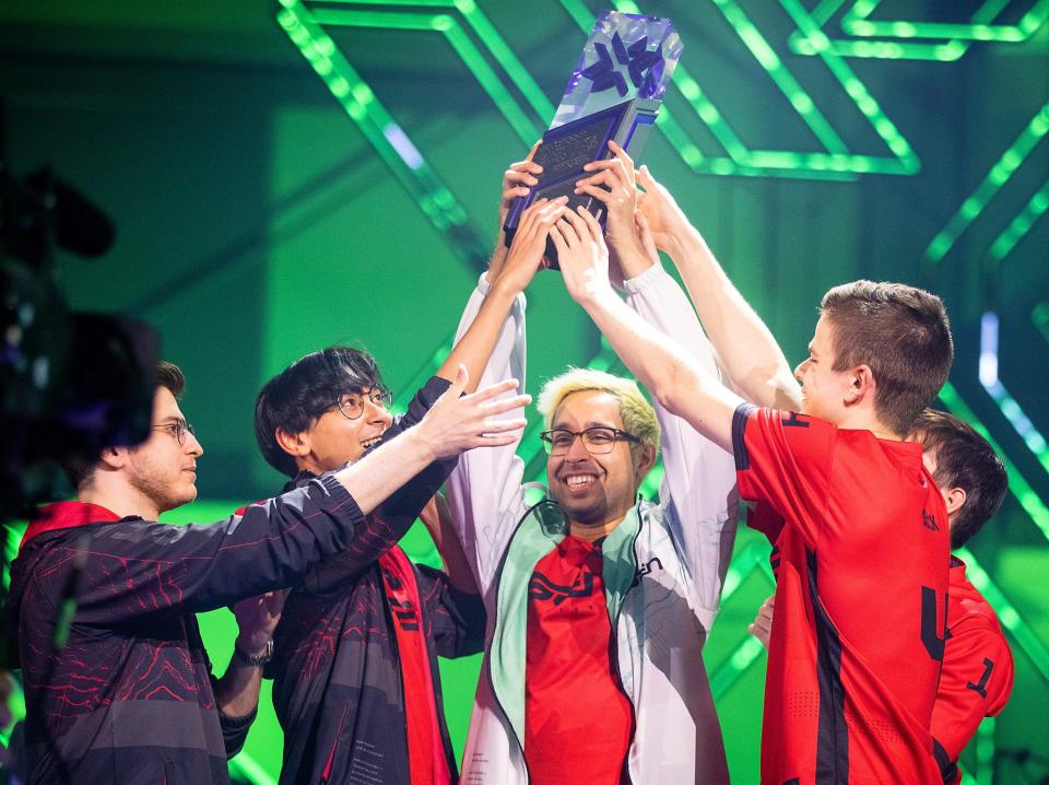 The North American "Valorant" team Sentinels holding up a triangular prism trophy