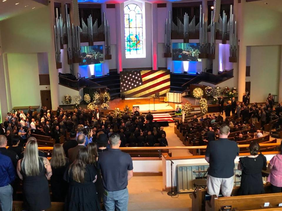 Mourners stand inside First Baptist Church for fallen CMPD Officer Joshua Eyer service.