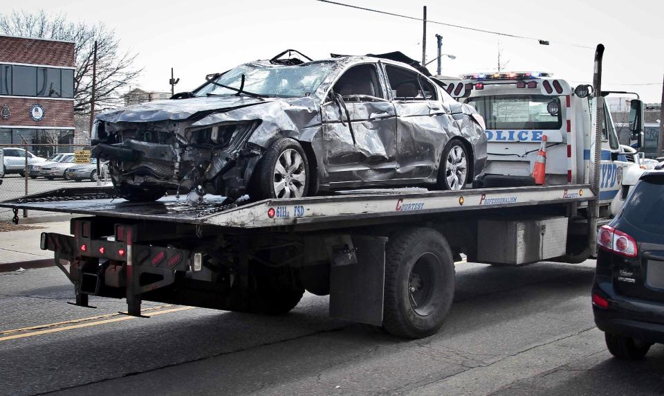 Police remove a 2009 Honda Accord recovered from the Steinway Creek on Saturday April 5, 2014 in New York. The driver of the car drove off a dead-end street in a desolate industrial area, flipped over a wooden curb into the East River inlet killing four passengers. The driver escaped serious injury and told officers at the scene in the Astoria section of Queens that the four were trapped in the submerged car. Fire department divers pulled the four victims from the car. Police identified them as 21-year-old Darius Fletcher, 19-year-old Jada Monique Butts, 19-year-old Crystal Gravely and 20-year-old Jaleel Furtado. They were pronounced dead at hospitals. (AP Photo/Bebeto Matthews)