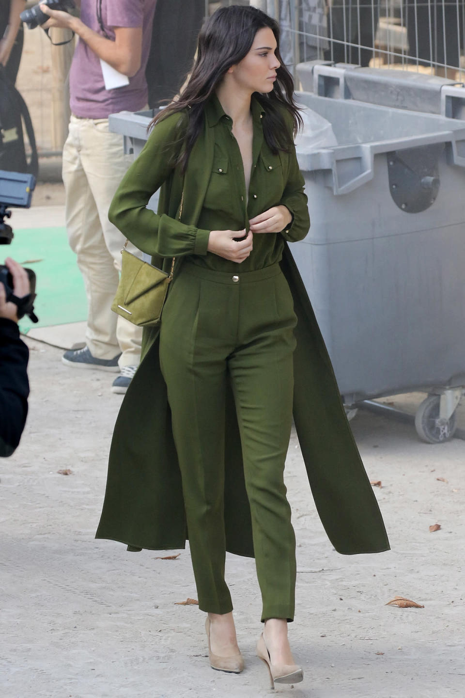 <p>Jenner took a style cue from her older sister Kim Kardashian on Saturday, wearing an all-green, monotoned getup as she dashed across Paris to the Elie Saab runway show. It’s a sleek and sophisticated look for Jenner, who left the buttons on her top undone almost to her waist. Kind of makes you forget she’s only 19, doesn’t it?</p>