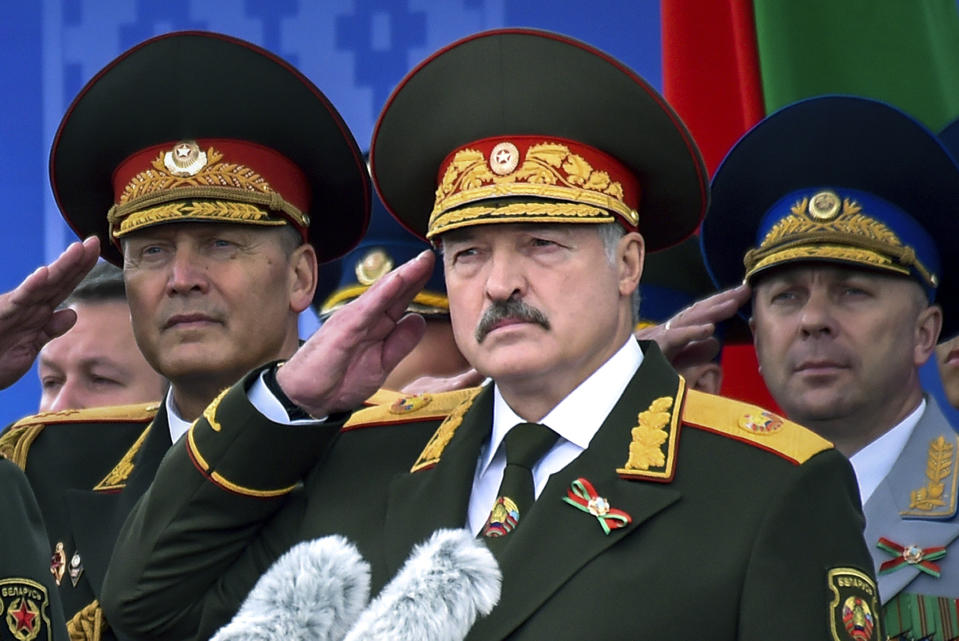 FILE In this file photo taken on Tuesday, July 3, 2018, Belarus President Alexander Lukashenko, center, attends a military parade marking Independence Day in Minsk, Belarus. Belarus’ authoritarian President Alexander Lukashenko faces a perfect storm as he seeks a sixth term in the election held Sunday, Aug. 9, 2020 after 26 years in office. Mounting public discontent over the worsening economy and his government’s bungled handling of the coronavirus pandemic has fueled the largest opposition rallies since the Soviet collapse. (Sergei Gapon/Pool Photo via AP, File)