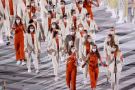 <p>Are the delegates from Netherlands heading to the opening ceremony or to the office? Some delegates wore belted burnt orange (the national color) and cream sleeveless jumpsuits, while others wore pinstripe suits. </p>