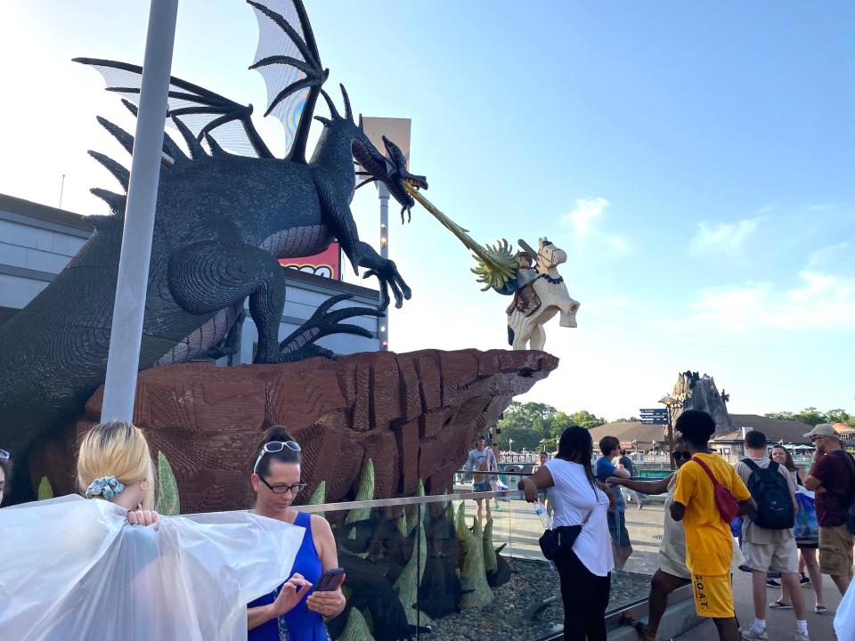 Disney fans gather around a Lego sculpture in Disney Springs.